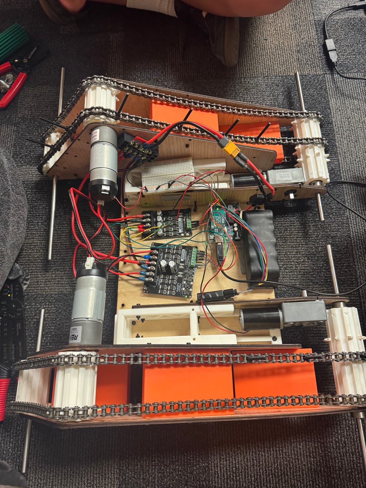 Chassis internals — Arduino, dual Cytron MD20A drivers, drive motors and battery